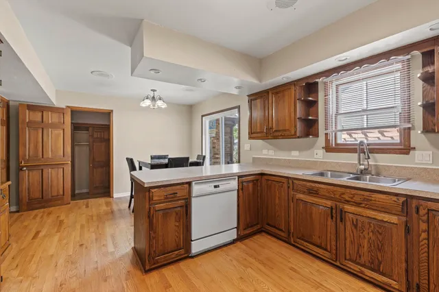 a kitchen with a sink cabinets and wooden floor
