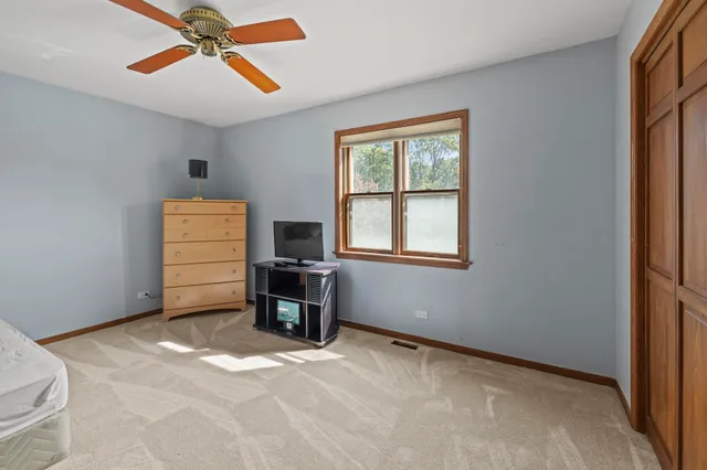 a bedroom with furniture and window