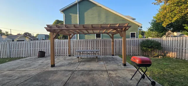 a patio with a table and chairs