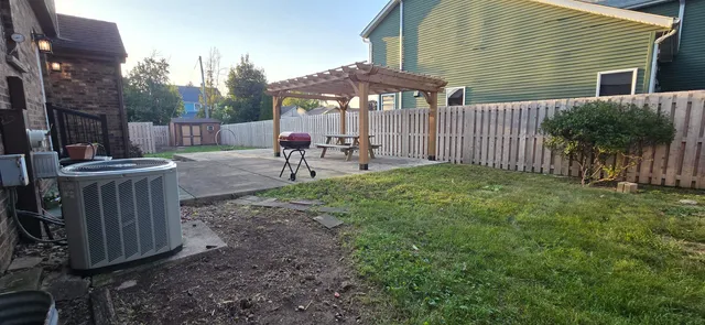a view of a backyard with wooden fence
