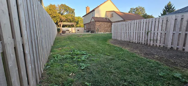 an aerial view of residential houses with outdoor space and city view