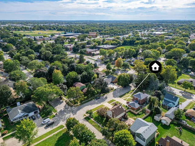 an aerial view of residential houses with outdoor space