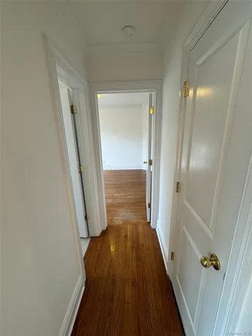 a view of a hallway view with wooden floor