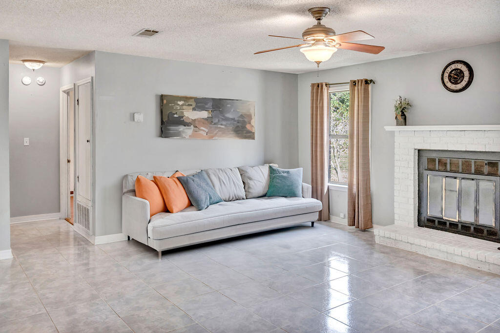 4712 Frontier Road Pace, FL 32571 - Photo 17 of 29 a living room with furniture and a fireplace