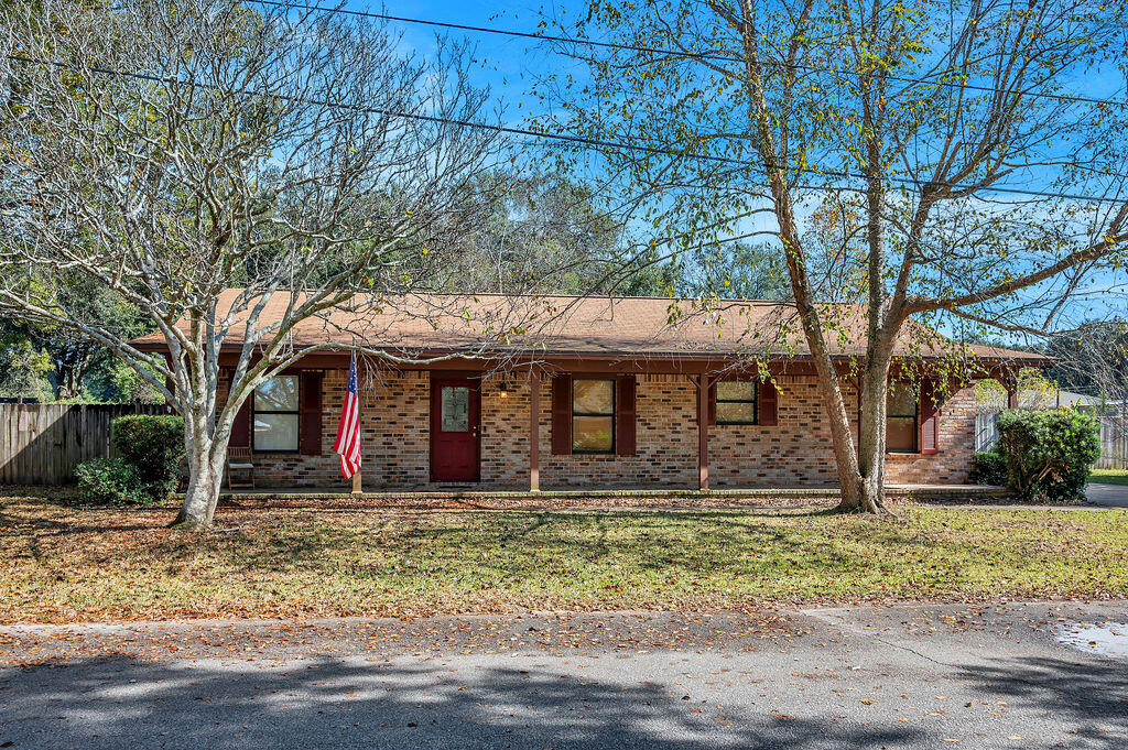 4712 Frontier Road Pace, FL 32571 - Photo 2 of 29 a backyard of a house with lots of green space