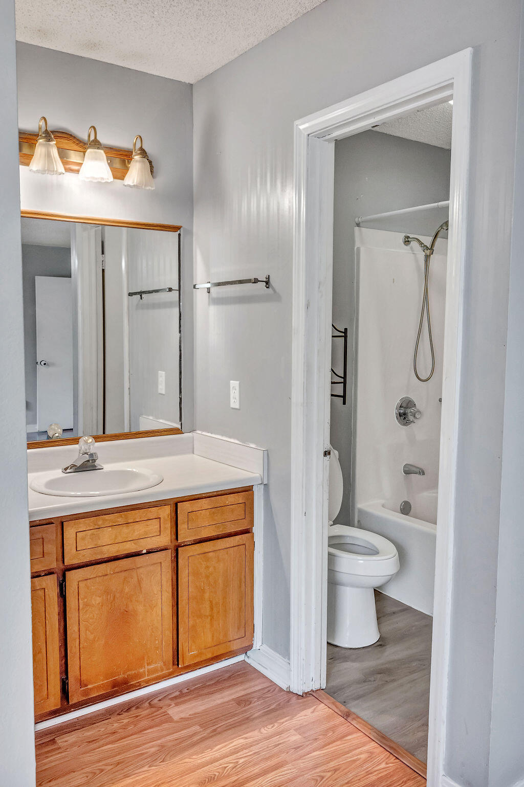 4712 Frontier Road Pace, FL 32571 - Photo 22 of 29 a spacious bathroom with a granite countertop sink toilet a large mirror a vanity and shower