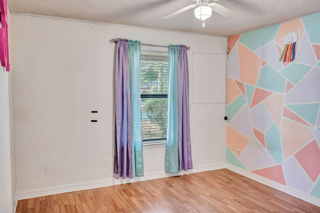 4712 Frontier Road Pace, FL 32571 - Photo 25 of 29 a view of an entryway with wooden floor