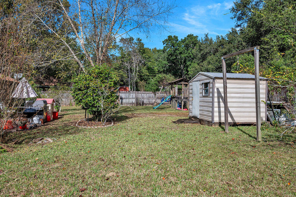 4712 Frontier Road Pace, FL 32571 - Photo 28 of 29 a view of a house with a yard and sitting area