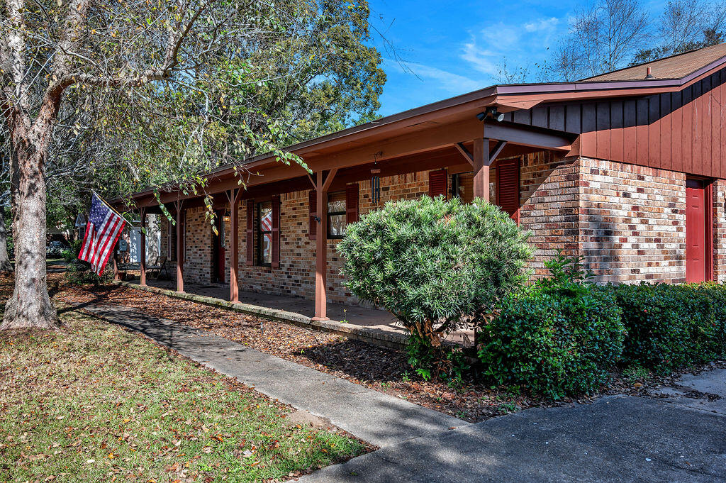 4712 Frontier Road Pace, FL 32571 - Photo 6 of 29 a front view of a house with a yard