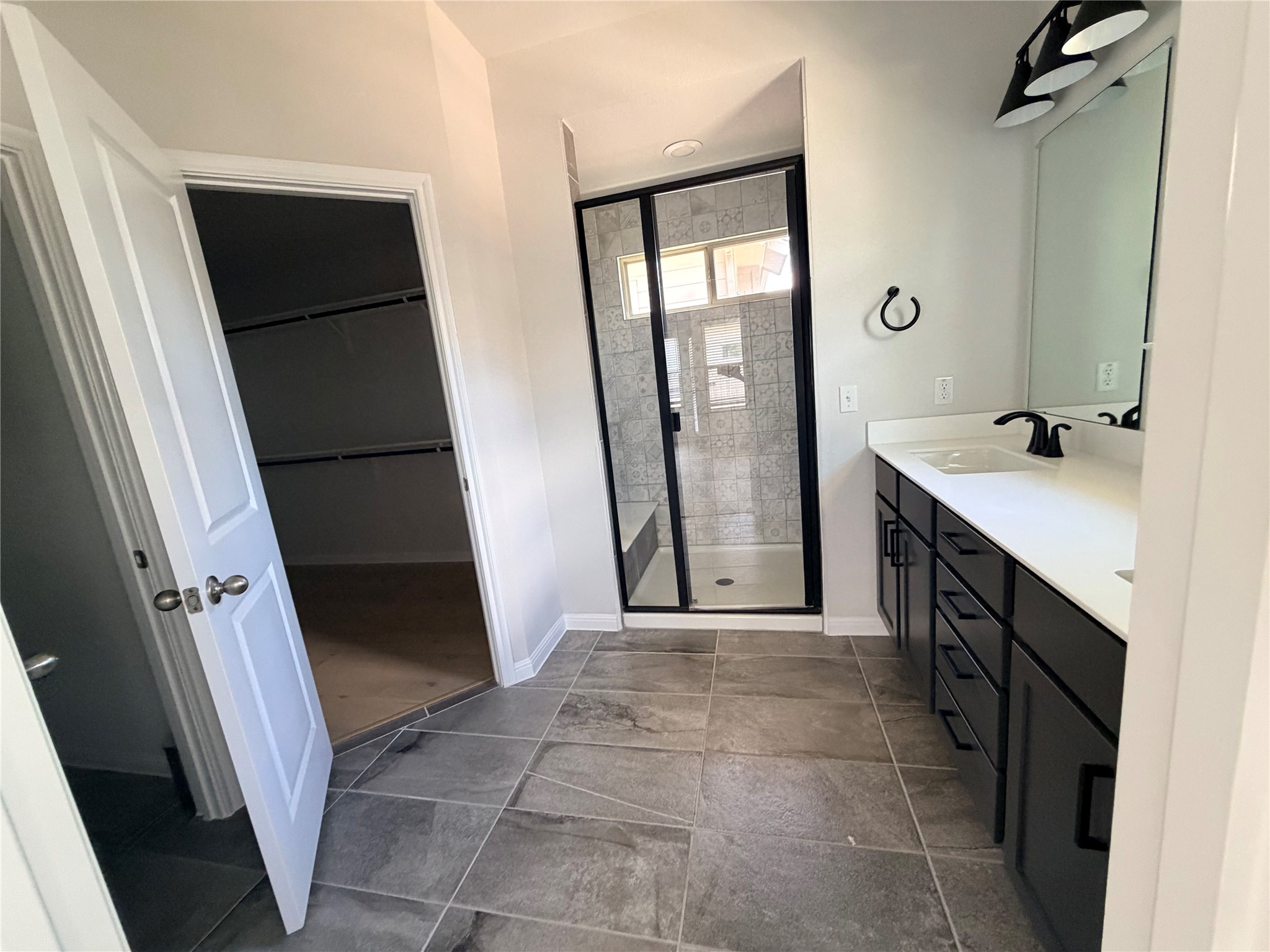 2813 Hopi Path, Unit 11 Leander, TX 78641 - Photo 13 of 17 Full bathroom featuring double vanity, a stall shower, and a walk in closet