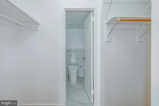 a bedroom with a bed and a flat tv screen