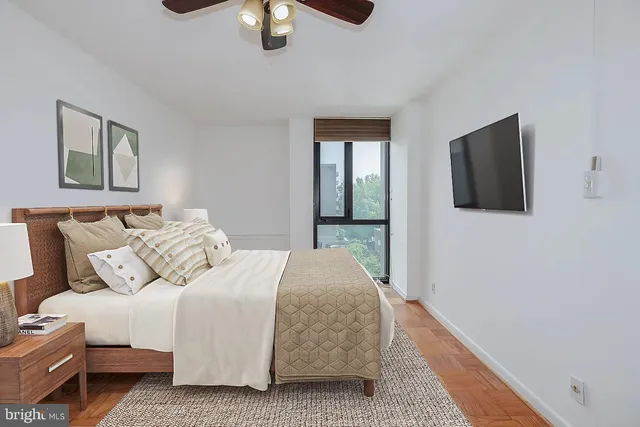 a bedroom with a bed and a flat screen tv