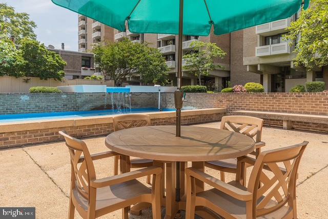1250 4th Street Southwest, Unit W403 Washington, DC 20024 - Photo 26 of 30 a view of a patio with swimming pool table and chairs