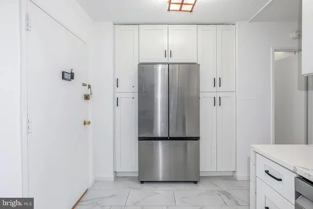 a kitchen with cabinets and a stove top oven