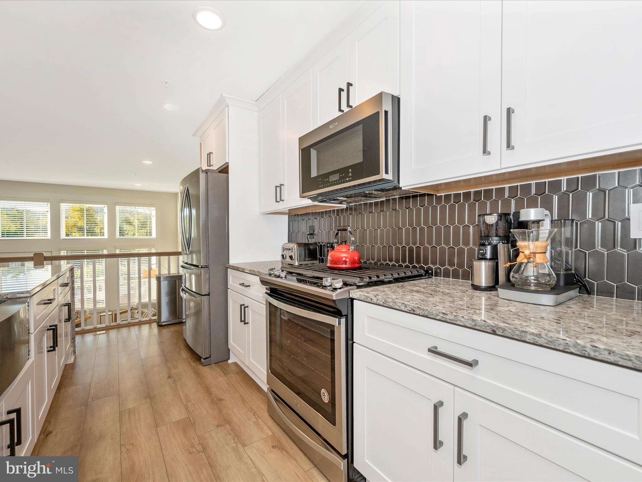740 Tatum Court Frederick, MD 21702 - Photo 15 of 53 a kitchen with stainless steel appliances granite countertop a stove and a wooden floors