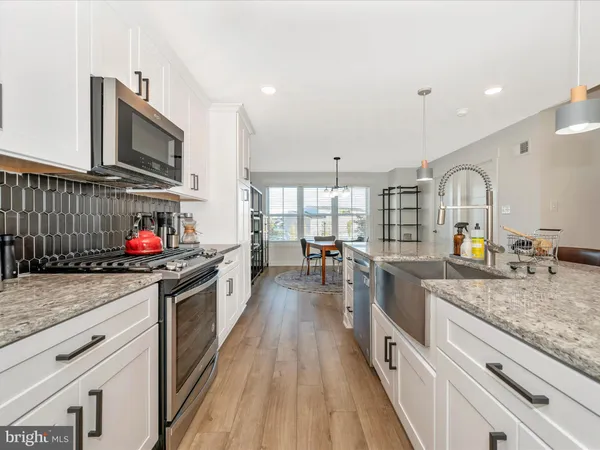 a kitchen with stainless steel appliances granite countertop a stove and a sink