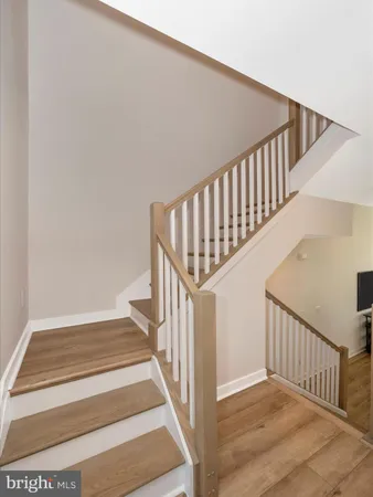 a view of a hallway with a livingroom and entryway