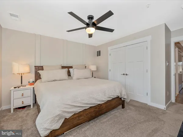 a bedroom with a large bed and a chandelier