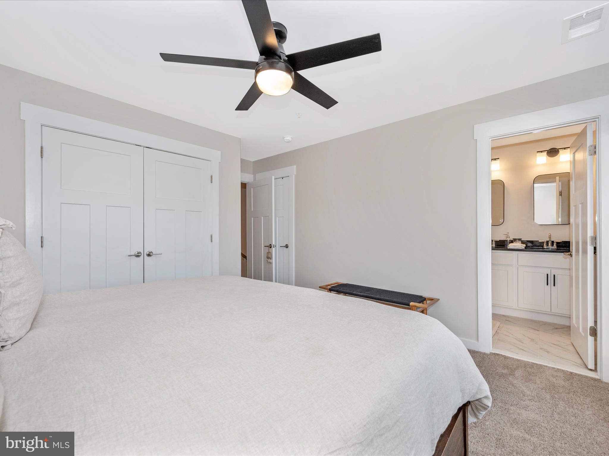 740 Tatum Court Frederick, MD 21702 - Photo 24 of 53 a bedroom with a large bed and a chandelier