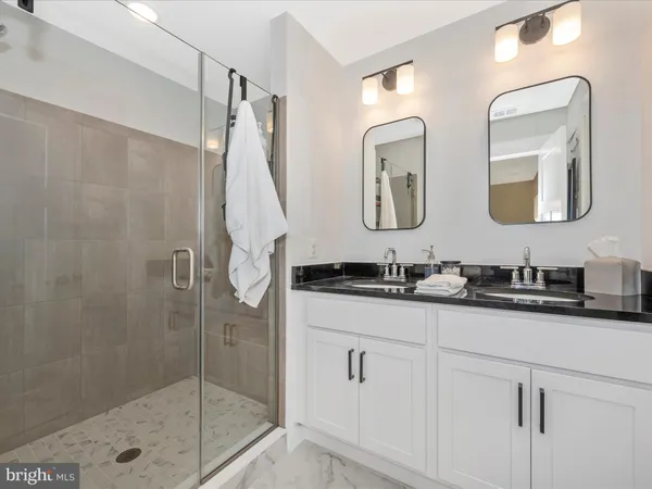 a bathroom with 2 sink and a mirror