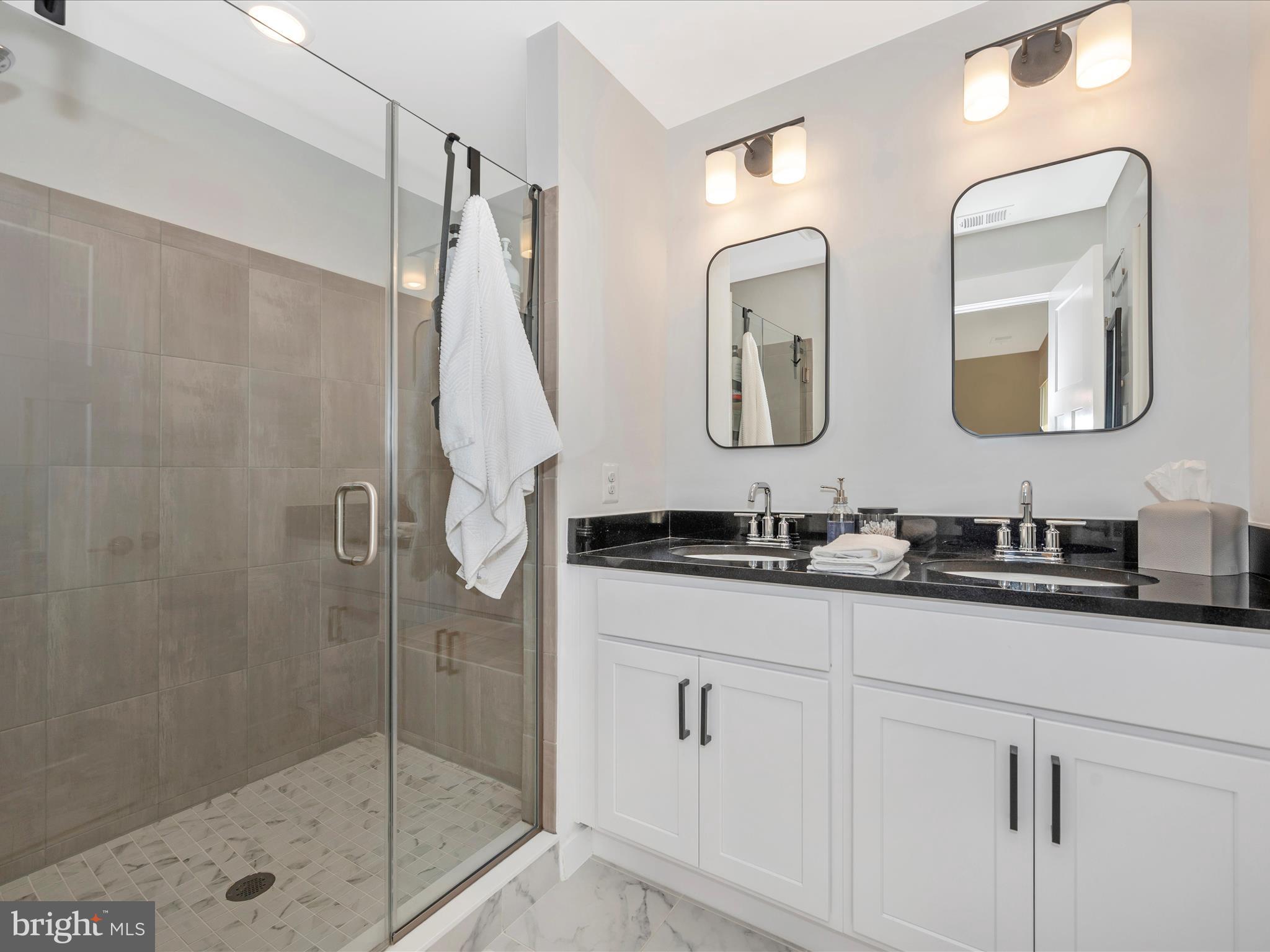 740 Tatum Court Frederick, MD 21702 - Photo 30 of 53 a bathroom with a double vanity sink mirror and shower