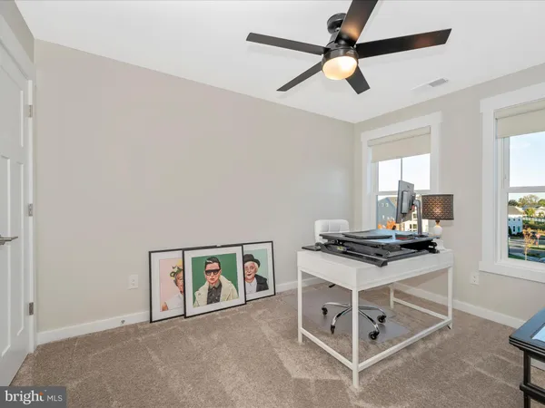 a bathroom with a granite countertop toilet sink and mirror