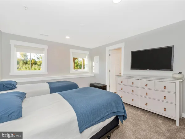 a bedroom with two beds and a window