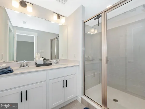 a bathroom with a double vanity sink and mirror