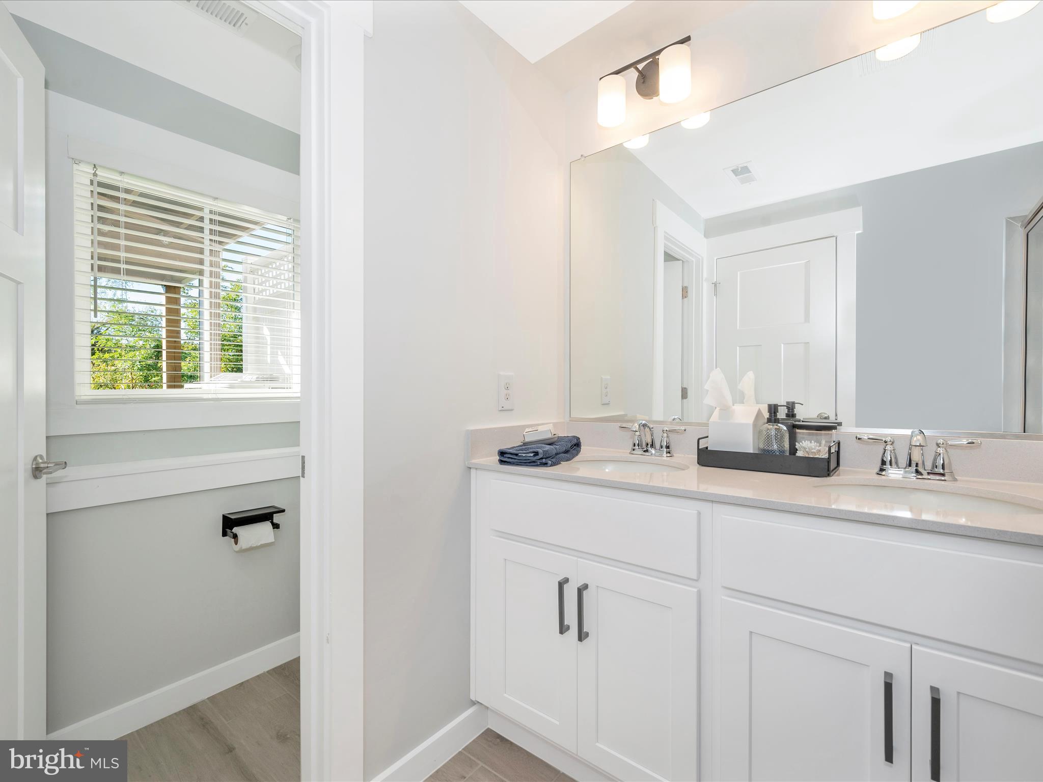 740 Tatum Court Frederick, MD 21702 - Photo 41 of 53 a bathroom with a double vanity sink and mirror