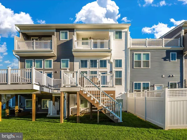 a view of a house with a deck and a yard