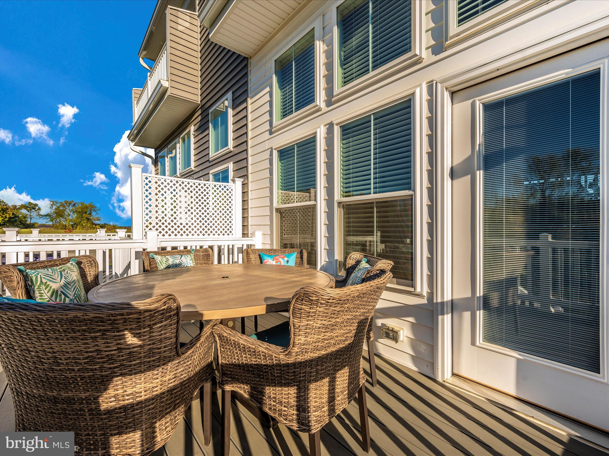 740 Tatum Court Frederick, MD 21702 - Photo 49 of 53 a view of a patio with a table and chairs and floor to ceiling window next to a building