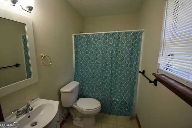 a bathroom with a toilet and a sink