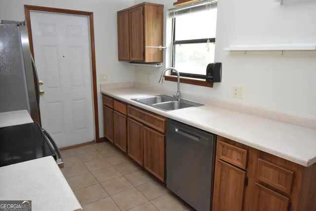 a kitchen with a sink window and cabinets