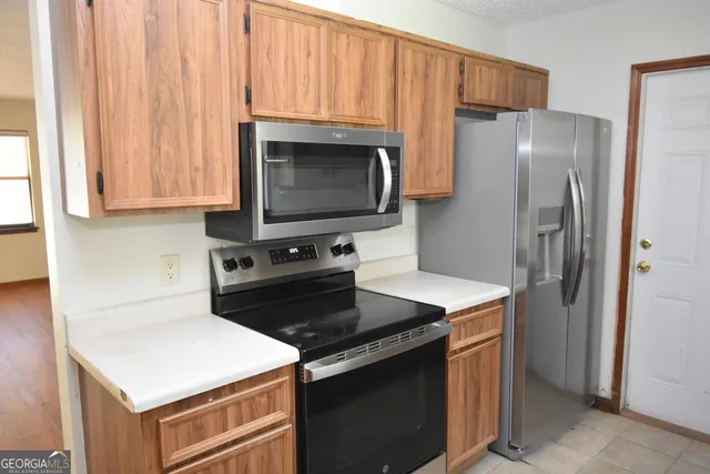 a kitchen with a stove microwave and refrigerator