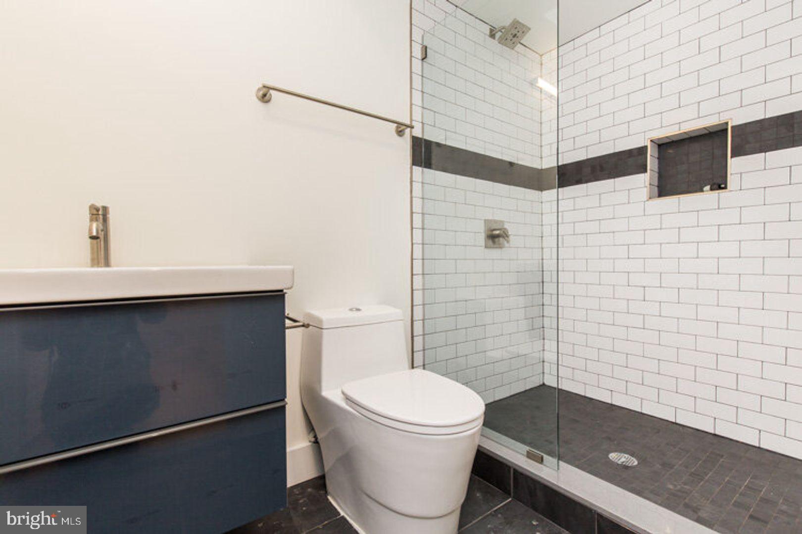 4100 Ludlow Street, Unit 1S Philadelphia, PA 19104 - Photo 16 of 16 a bathroom with a sink toilet and shower