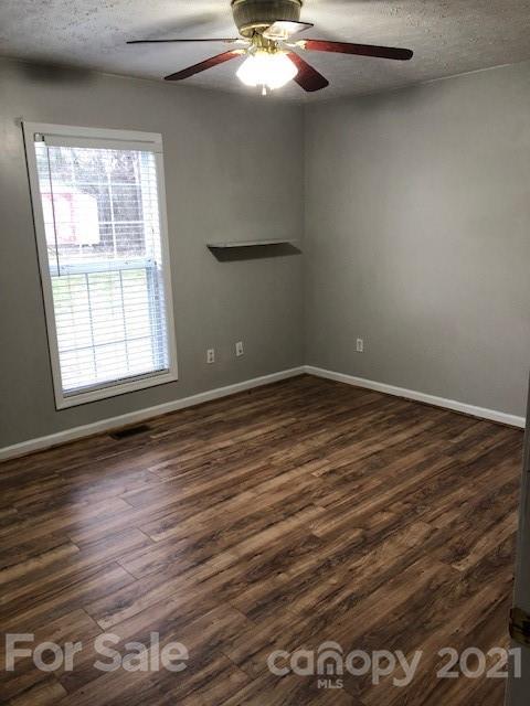 290 Sutton Spring Road York, SC 29745 - Photo 2 of 15 an empty room with wooden floor fan and windows