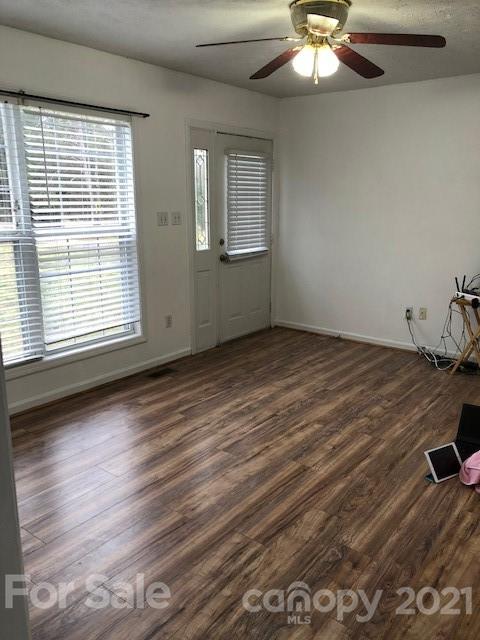 290 Sutton Spring Road York, SC 29745 - Photo 8 of 15 an empty room with wooden floor fan and windows