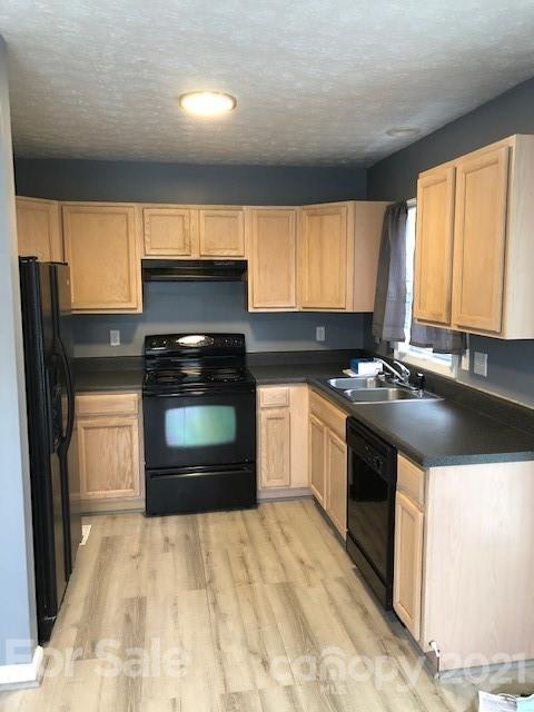 290 Sutton Spring Road York, SC 29745 - Photo 9 of 15 a kitchen with granite countertop a stove a sink and a microwave