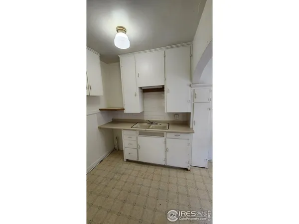 a room with a sink and cabinets