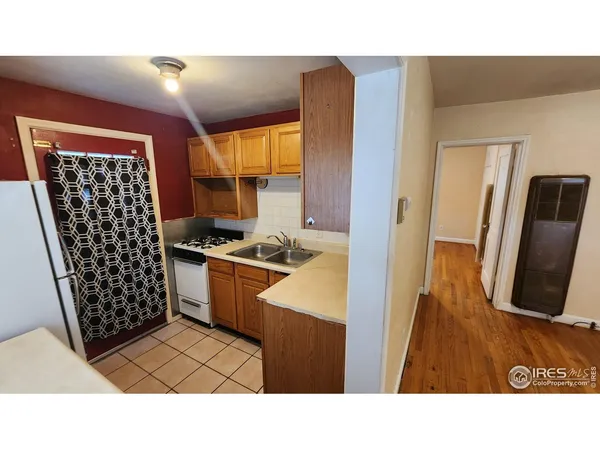 a open kitchen with sink and cabinets