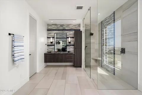 a kitchen with granite countertop a sink a stove and refrigerator