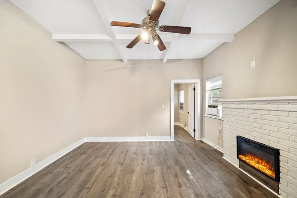 wooden floor in an empty room with a fireplace