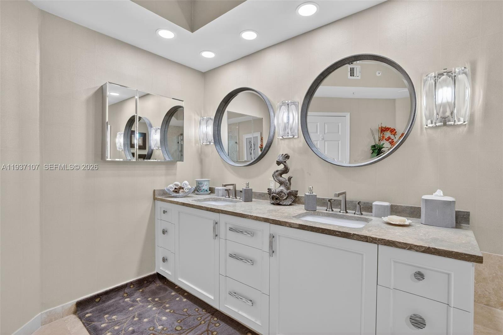 100 South Birch Road, Unit 1103F Fort Lauderdale, FL 33316 - Photo 43 of 80 Primary bathroom w/ custom wood vanity & upgraded hardware. Beautiful stone vanity counter, wall coverings, sconces, separate medicine cabinet and mirrors.