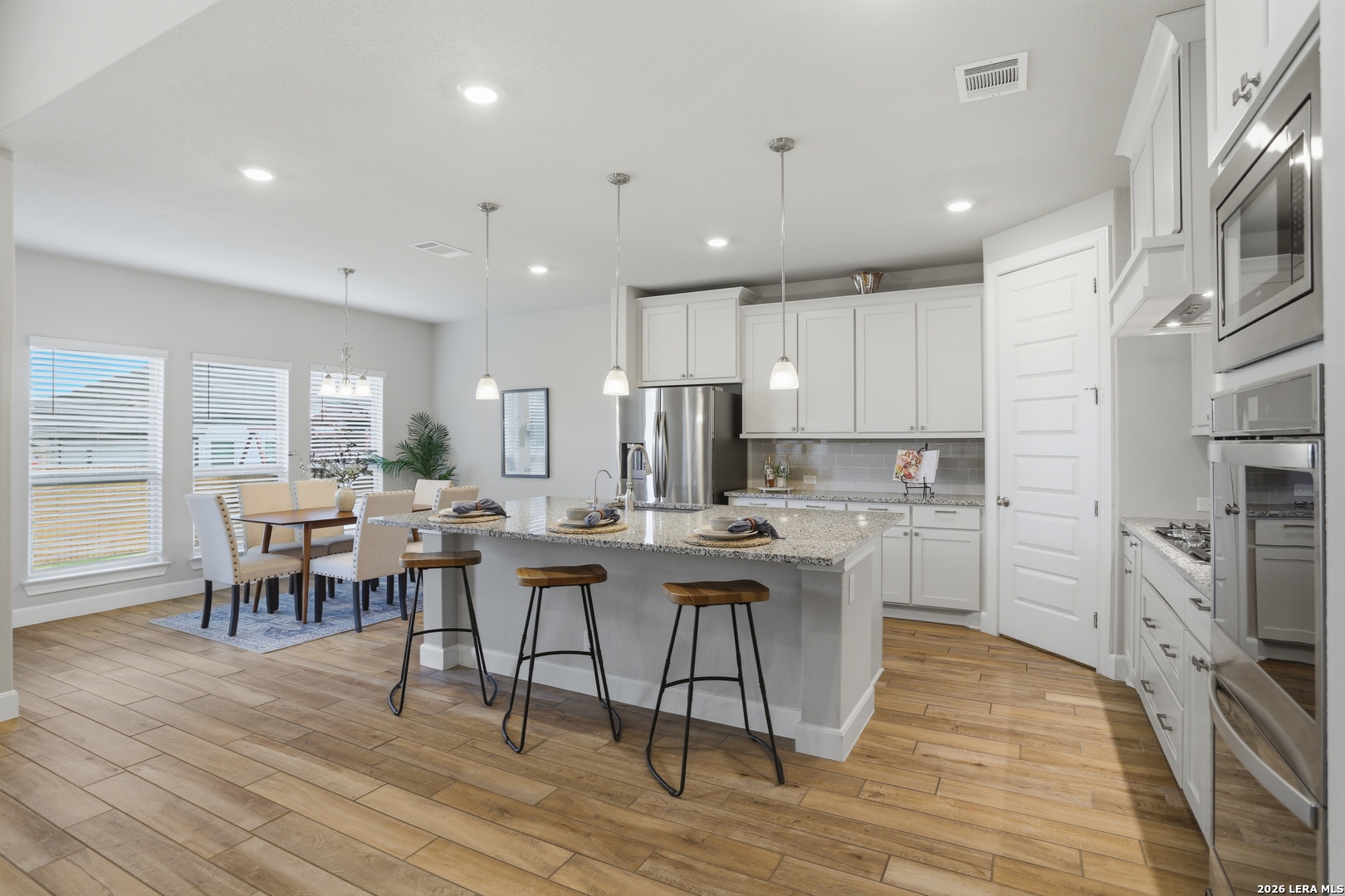 337 Misty Sails Cibolo, TX 78108 - Photo 13 of 50 a kitchen with cabinets table and stainless steel appliances