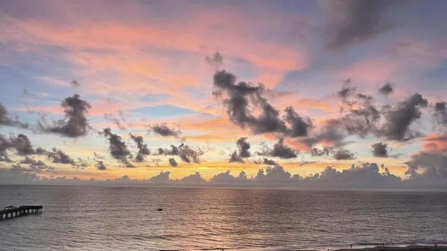 a dining room with stainless steel appliances kitchen island granite countertop a table and chairs