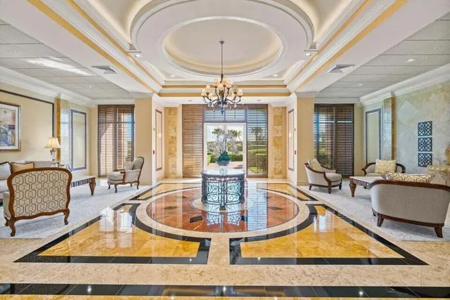 a view of a dining room with furniture and chandelier