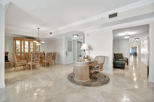 a view of a chairs and table on the roof deck