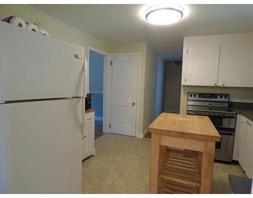 696 Bay Road Amherst, MA 01002 - Photo 6 of 25 a kitchen with a refrigerator and a stove top oven