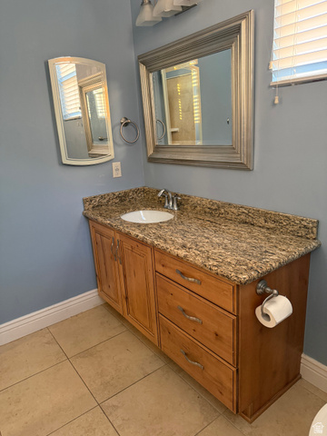 2388 East 850 South Springville, UT 84663 - Photo 23 of 24 Vanity with granite-style countertop, integrated sink, and wood-finish cabinetry