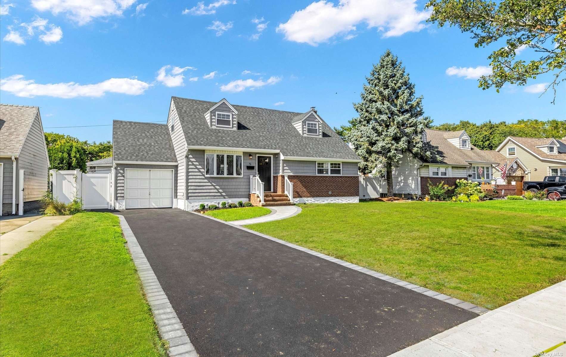 5 Morris Road Bethpage, NY 11714 - Photo 1 of 1 a front view of house with yard and green space